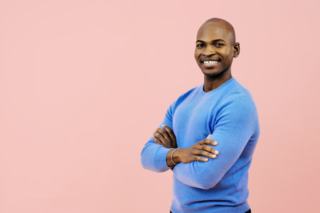 man smiling with folded arms looking at cameraの写真素材