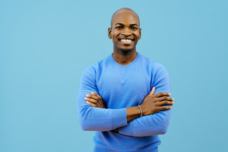 man smiling with folded arms looking at cameraの写真素材