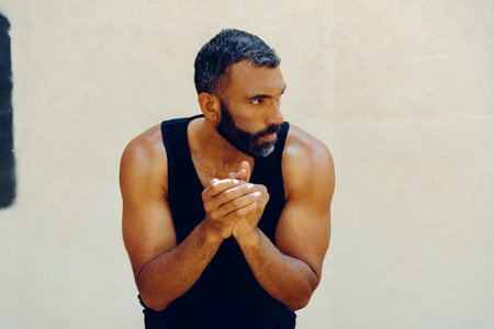 A Moment of Reflection. Bearded Man with Hands Clasped Looking Awayの写真素材