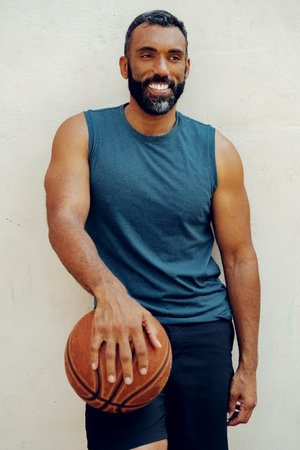 Athletic Man Basketball Player Holding Ballの写真素材