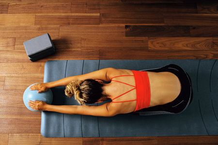top view of woman stretching in sportswear outfit, pilates, exerciseの写真素材