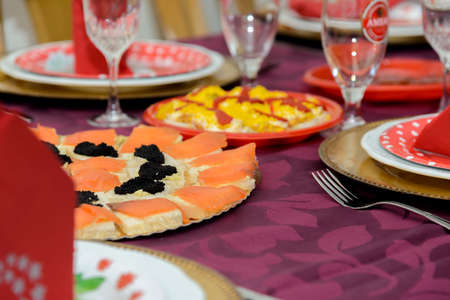 Christmas dinner table with fish and special decorationの写真素材