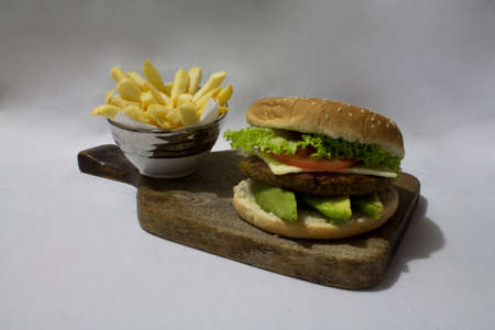 Hamburger accompanied by french fries on white background.の写真素材