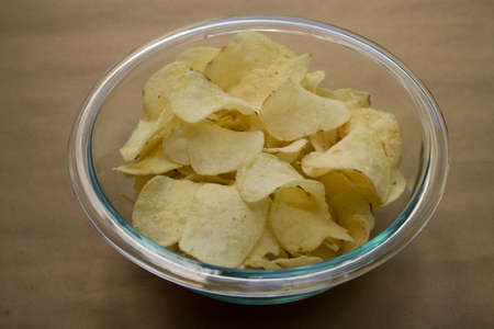 Delicious and crispy potato chips in a bowl.の写真素材