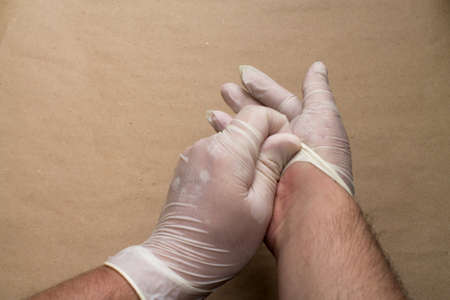A man removes disposable gloves.の写真素材