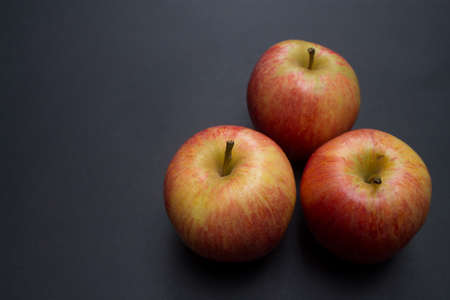 Three apples on black background.の写真素材