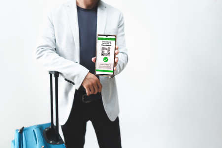 executive man shows his QR code certificate of vaccine against  on the screen of his mobile phone. High quality photoの写真素材
