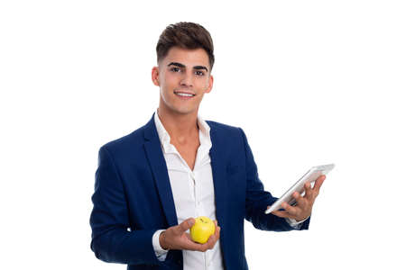young smiling businessman carrying a tablet mobile and an appleの写真素材