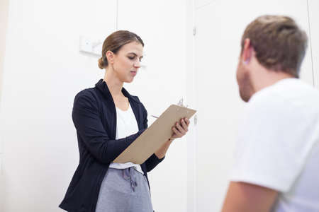 female physiotherapist consults young patientの写真素材