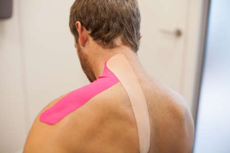 shoulder treatment with pink physio tapeの写真素材