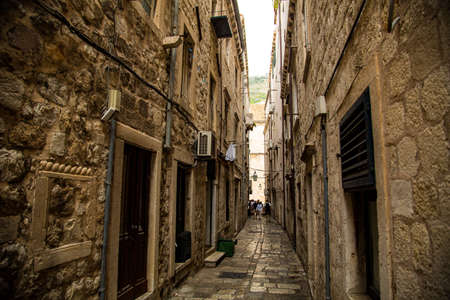 Duvrobnik city in Croatia, medieval walls and narrow streets on the side of a large mountain with port and bay within the wallの写真素材