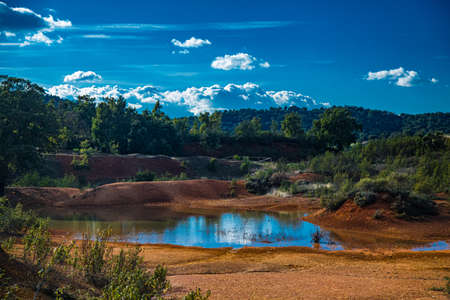 Natural park of eroded stone and red sand forest, with abandoned iron mine. Iron hillの写真素材
