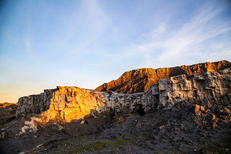 Abandoned mining operation with large coal dumps and town with dilapidated buildingsの写真素材