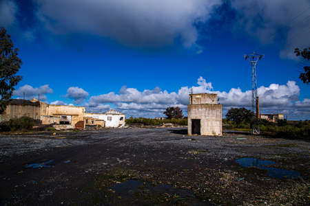 Abandoned mining operation with large coal dumps and village with dilapidated buildingsの写真素材