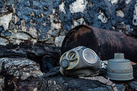 Weathered metal drum, in tar raft with gas maskの写真素材