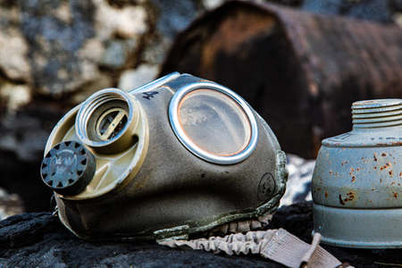 Weathered metal drum, in tar raft with gas maskの写真素材