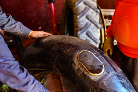 Fixing a wheel in repair shopの写真素材