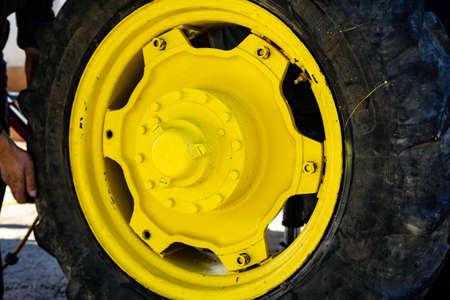 Yellow tractor wheel changeの写真素材