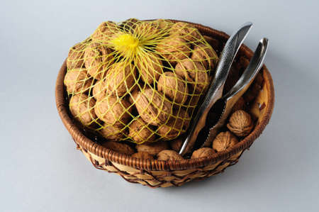Basket with nuts and nutcrackerの写真素材
