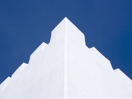 White wall in blue sky