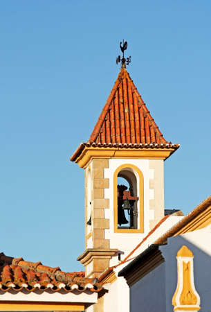 Tower Church bell with cardinal points cock on the top of the roofの写真素材