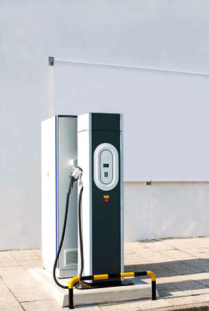 New charging station for electric car with a white canvas panel for outdoor advertisingの写真素材