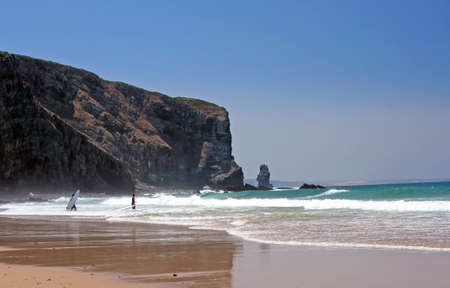 Entrance on the water of two surfers in Arrifana beach in the atlantic coast of Alentejo, Portugalの写真素材