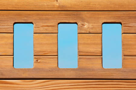 Three windows in a natural wood planksの写真素材