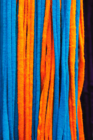 Orange and blue mesh hanging on a black backgroundの写真素材