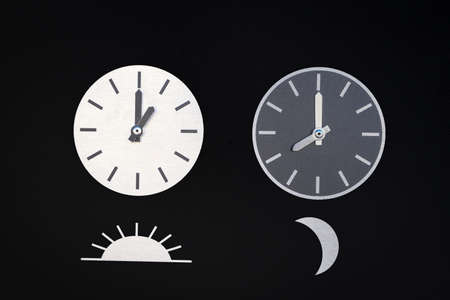 Moon & Sun clocks in a black backgroundの写真素材