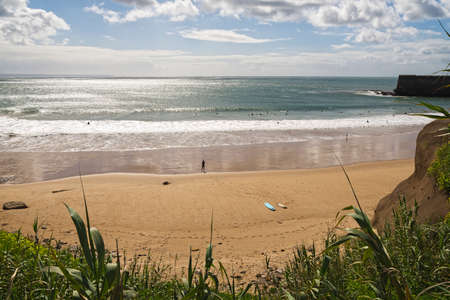 Several surfing in the tower beach in Oeiras, Portugalの写真素材