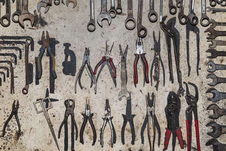 An old shelf, in a mechanic workshop, with pliers and wrenchsの写真素材