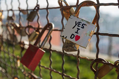 Several padlocks of love vows locked in a gri