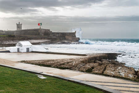 Saint Julian Fort viewed from Carcavelos beach, in a storm day in Cascais, Portugalの写真素材