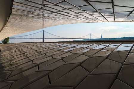 View of the 25 April bridge and the statue of the king Christ, from north margin of the tagus river, in Lisbon, Portugalの写真素材