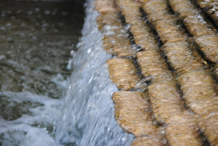 Water flowing from a roof of a house in the countryside, close-upの写真素材