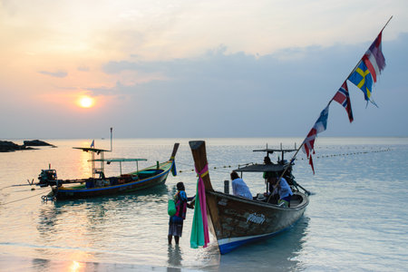 People travelling on longtail at Thailandの写真素材