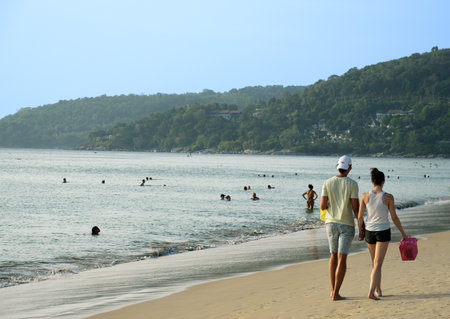 European couple walking along the beach on holidaysの写真素材