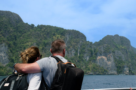 Mature marriage on honeymoon observing the horizon views from a boatの写真素材