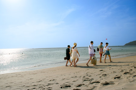 Friends walking on the beach on holidaysの写真素材