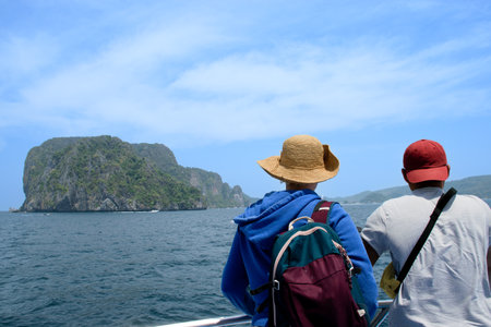 Friends watching the sea and islands from a ferry boatの写真素材