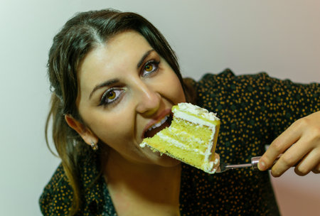 Woman eating a piece of cakeの写真素材