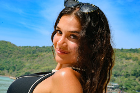 Gorgeous Lebanese young woman enjoying on beach and posing with sunglassesの写真素材