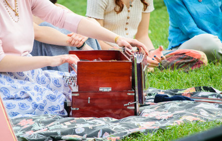 Hands playing Harinaam Harmonium Piano with light and cheerful clothesの写真素材