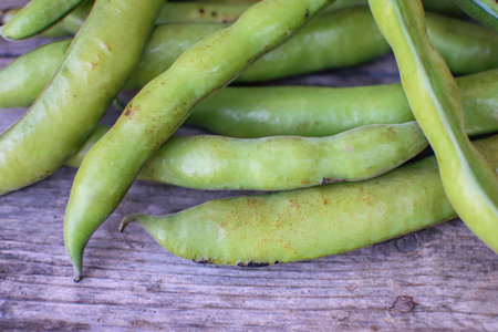 Image of green broad stocked in market for consumption.の写真素材