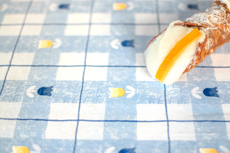 Freshly made Cannolo pastry in blue table background