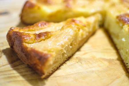 Freshly made Apple Cake sliced in wooden background.の写真素材