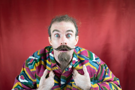 Hipster man with mustache showing culpability expression shock and surpriseの写真素材