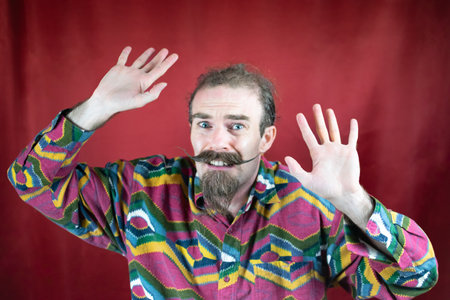 Hipster terrified man with mustache, hands raised in defense and fear expressionの写真素材