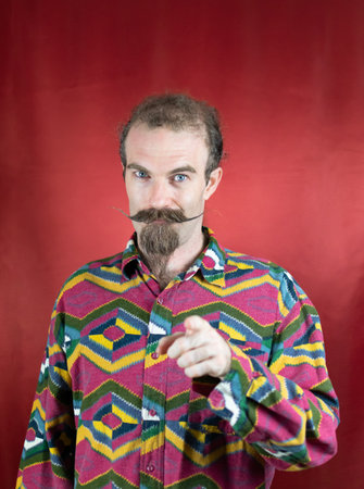 Hipster man confident showing approbation and pointing with finger at cameraの写真素材